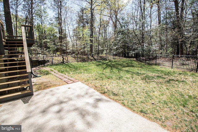 view of yard with a patio area, stairway, and fence private yard