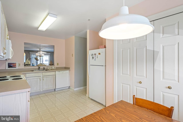 30381 Crowley Dr Unit 309, Ocean View, DE 19970 - kitchen featuring light countertops, decorative light fixtures, white appliances, a sink, and light floors