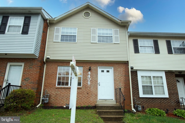townhome / multi-family property with brick siding