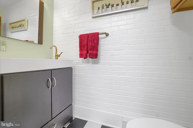 157 Hartswick Ave, State College, PA 16803 - bathroom with toilet, brick wall, and vanity