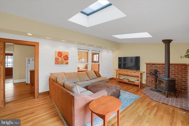 157 Hartswick Ave, State College, PA 16803 - living room with baseboards, light wood finished floors, a skylight, a wood stove, and recessed lighting