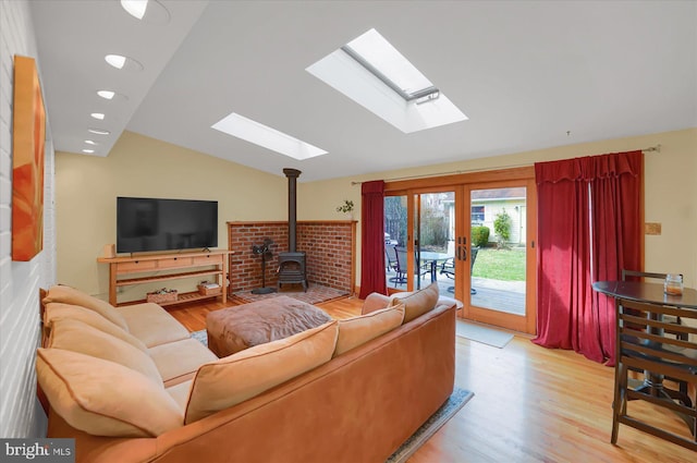 157 Hartswick Ave, State College, PA 16803 - living area with wood finished floors, vaulted ceiling with skylight, french doors, and a wood stove