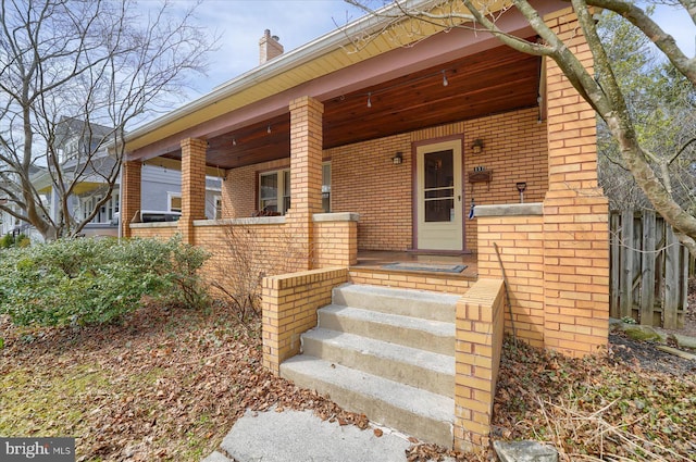 157 Hartswick Ave, State College, PA 16803 - view of exterior entry with brick siding, a porch, and a chimney