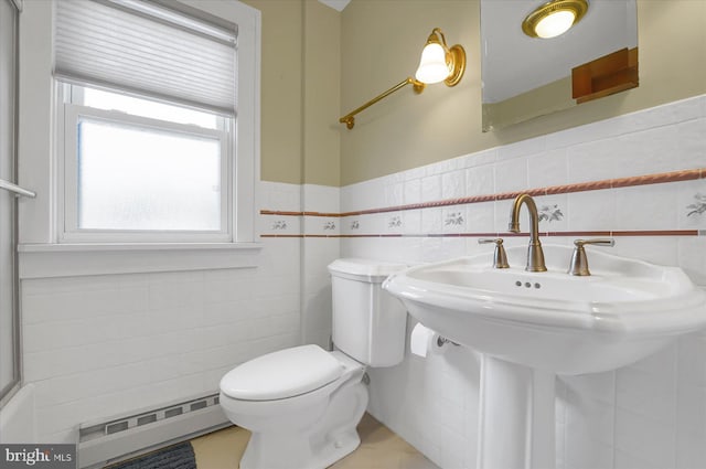 157 Hartswick Ave, State College, PA 16803 - bathroom with a baseboard radiator, a sink, wainscoting, tile walls, and toilet