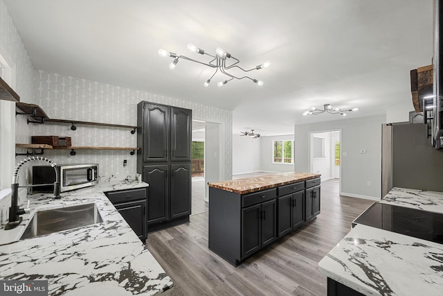 246 Locust Ln, Edinburg, VA 22824 - kitchen with a sink, a chandelier, open shelves, a kitchen island, and appliances with stainless steel finishes
