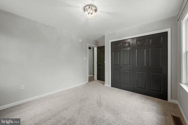 246 Locust Ln, Edinburg, VA 22824 - unfurnished bedroom with a closet, baseboards, ornamental molding, carpet flooring, and an inviting chandelier