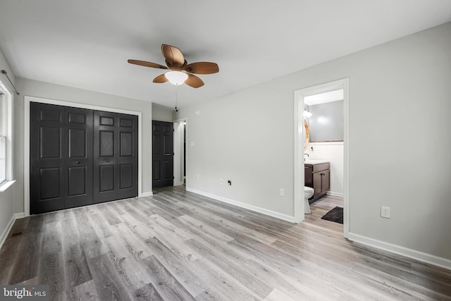 246 Locust Ln, Edinburg, VA 22824 - unfurnished bedroom with wood finished floors, a closet, baseboards, ceiling fan, and ensuite bath