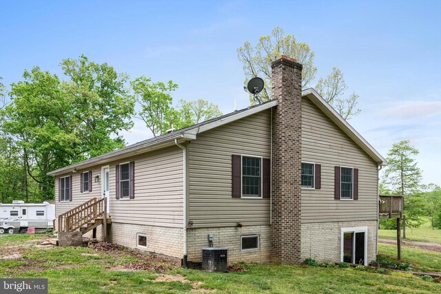 246 Locust Ln, Edinburg, VA 22824 - view of home's exterior featuring a yard, a chimney, and central AC