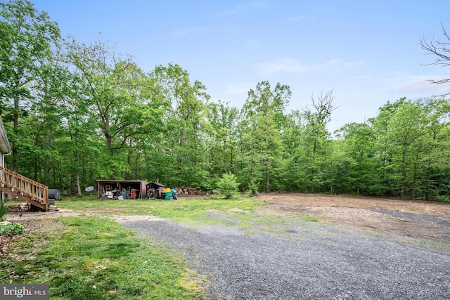 246 Locust Ln, Edinburg, VA 22824 - view of street featuring stairway, a view of trees, and gravel driveway