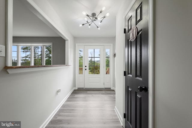 246 Locust Ln, Edinburg, VA 22824 - doorway to outside with baseboards, an inviting chandelier, and wood finished floors
