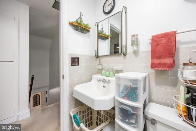 26547 Old State Rd, Crisfield, MD 21817 - bathroom with tile walls, a sink, toilet, and wainscoting