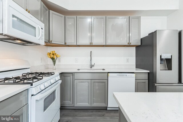 2540 Merganser Ct, Waldorf, MD 20601 - kitchen with light countertops, white appliances, wood finished floors, a sink, and gray cabinetry