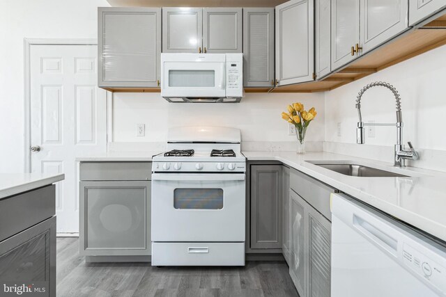 2540 Merganser Ct, Waldorf, MD 20601 - kitchen with light countertops, light wood finished floors, white appliances, a sink, and gray cabinetry
