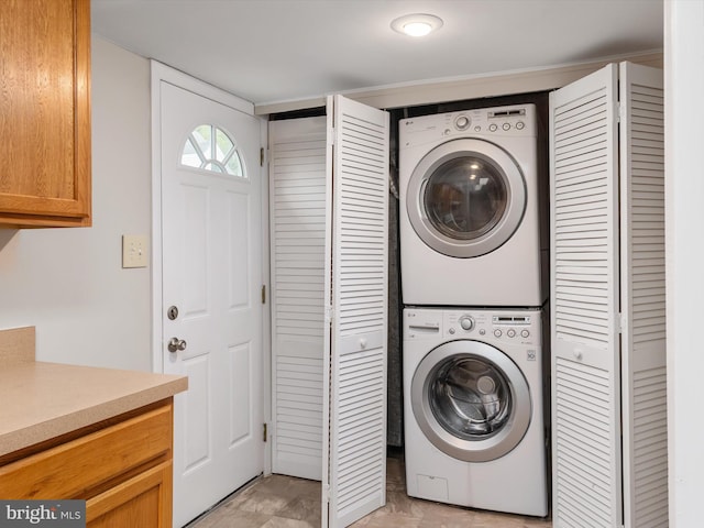 washroom with stacked washer / dryer and laundry area