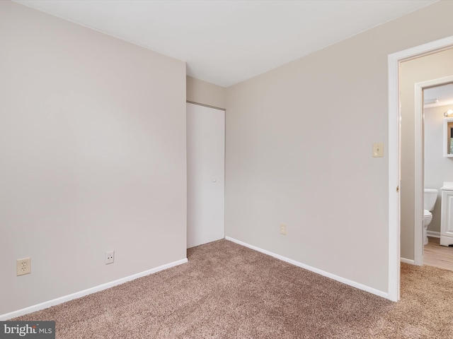 unfurnished bedroom with baseboards and carpet flooring