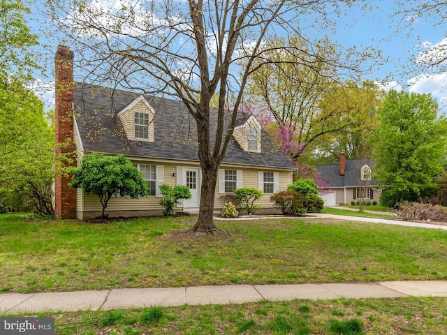 cape cod house with a chimney and a front lawn