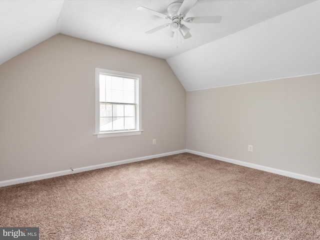 bonus room featuring ceiling fan, vaulted ceiling, carpet floors, and baseboards