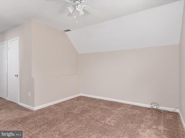 additional living space with vaulted ceiling, a ceiling fan, baseboards, carpet flooring, and visible vents