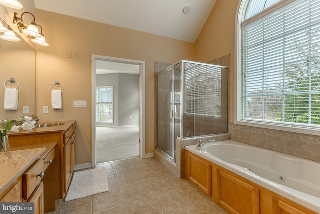 bathroom with tile patterned flooring, vanity, vaulted ceiling, a shower stall, and a jetted tub