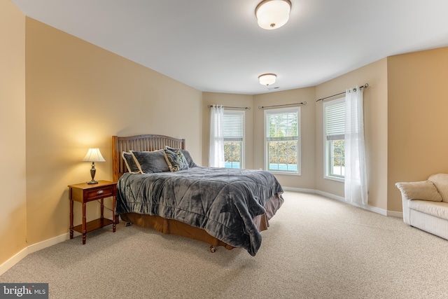 carpeted bedroom featuring baseboards