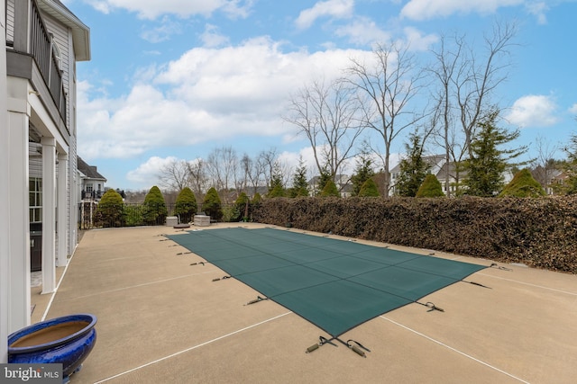 view of swimming pool featuring a fenced in pool, fence, and a patio area