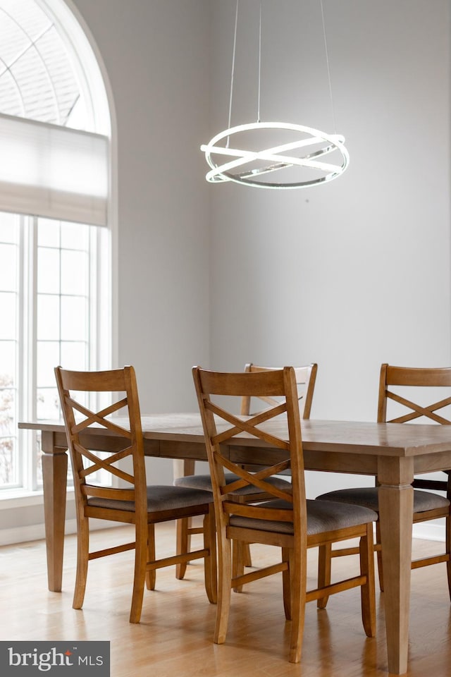 dining area with light wood-style flooring and a chandelier
