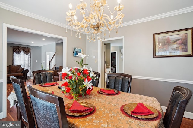 6301 Bradford Ct, Frederick, MD 21701 - dining space featuring wood finished floors, an inviting chandelier, ornamental molding, and stairs
