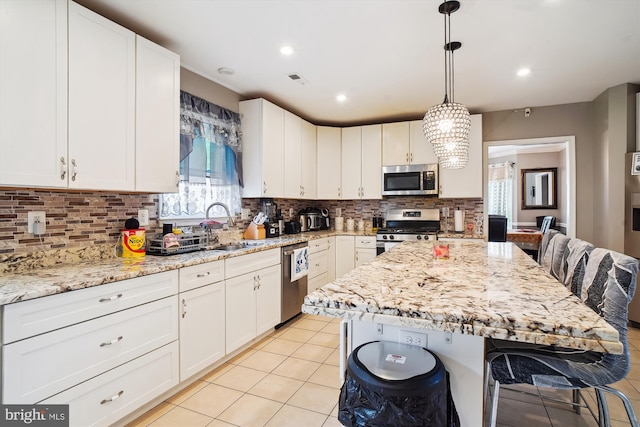 6301 Bradford Ct, Frederick, MD 21701 - kitchen with a sink, decorative backsplash, appliances with stainless steel finishes, and light stone counters