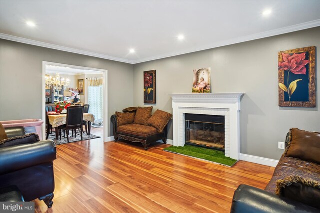 6301 Bradford Ct, Frederick, MD 21701 - living room featuring light wood-type flooring, an inviting chandelier, crown molding, and baseboards