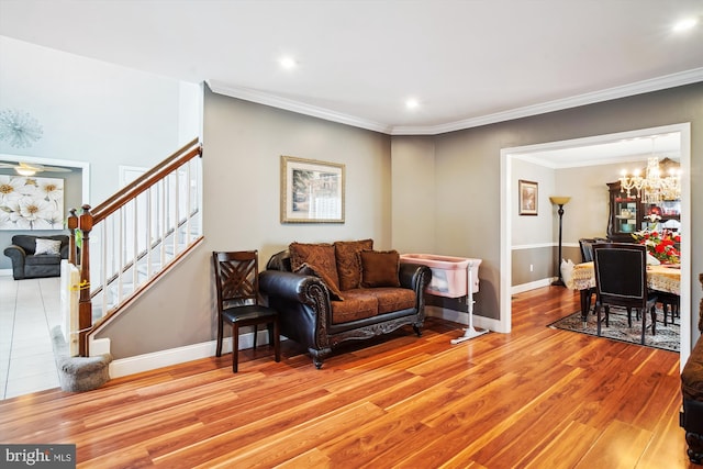 6301 Bradford Ct, Frederick, MD 21701 - living area featuring ornamental molding, light wood-style flooring, stairway, and an inviting chandelier