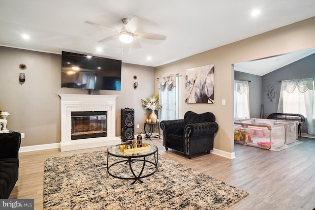6301 Bradford Ct, Frederick, MD 21701 - living room featuring baseboards, a ceiling fan, a fireplace, vaulted ceiling, and wood finished floors
