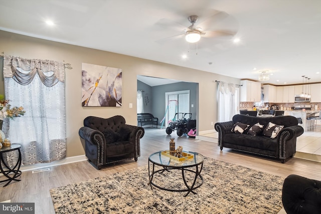 6301 Bradford Ct, Frederick, MD 21701 - living room with light wood-type flooring, baseboards, a ceiling fan, and visible vents