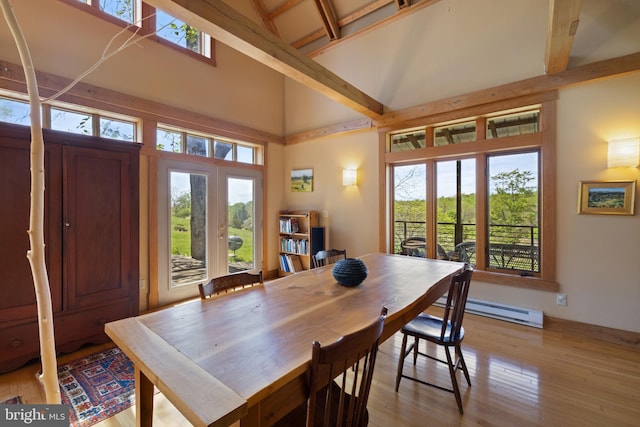 dining room with french doors, baseboard heating, beam ceiling, high vaulted ceiling, and light wood-style floors