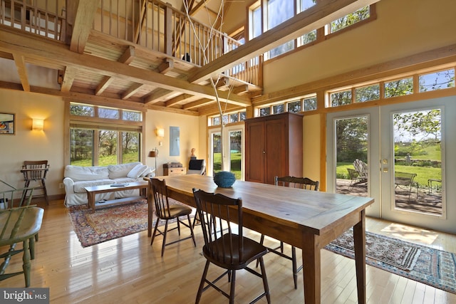 dining area with french doors, a healthy amount of sunlight, and beamed ceiling