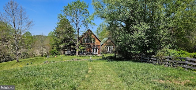 exterior space with a lawn and fence