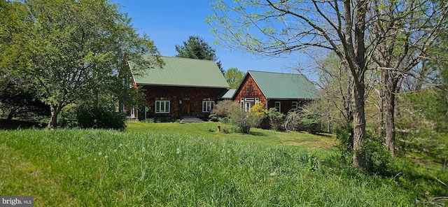 back of house with metal roof