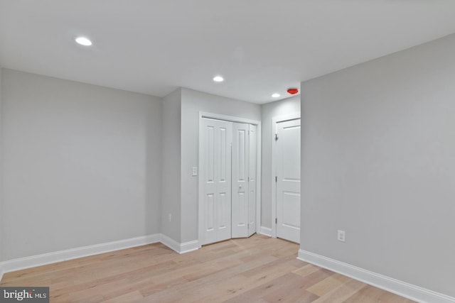 interior space featuring recessed lighting, a closet, baseboards, and light wood-type flooring
