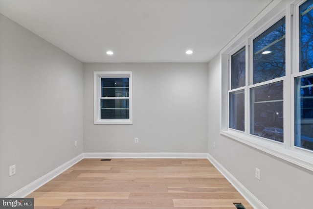 unfurnished room featuring baseboards, light wood-style flooring, and recessed lighting
