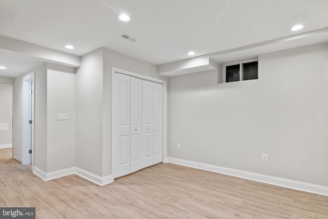 finished below grade area featuring baseboards, visible vents, wood finish floors, and recessed lighting