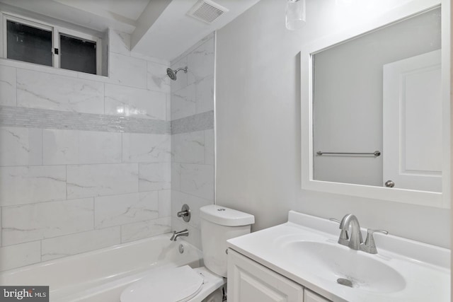 bathroom featuring visible vents, toilet, vanity, and shower / washtub combination