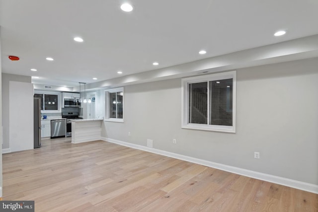 unfurnished living room with recessed lighting and light wood-style floors