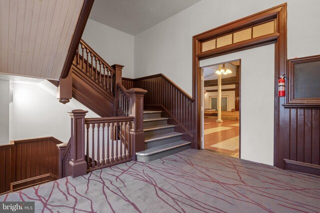 336 7th St N, Lebanon, PA 17042 - stairway with carpet flooring, a chandelier, and wainscoting