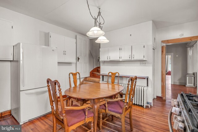 336 7th St N, Lebanon, PA 17042 - dining area with radiator, baseboards, and light wood finished floors