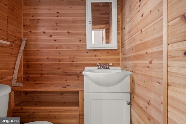 336 7th St N, Lebanon, PA 17042 - half bathroom with vanity, toilet, and wood walls