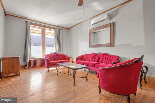 336 7th St N, Lebanon, PA 17042 - living room with crown molding, ceiling fan, radiator heating unit, a wall unit AC, and wood-type flooring