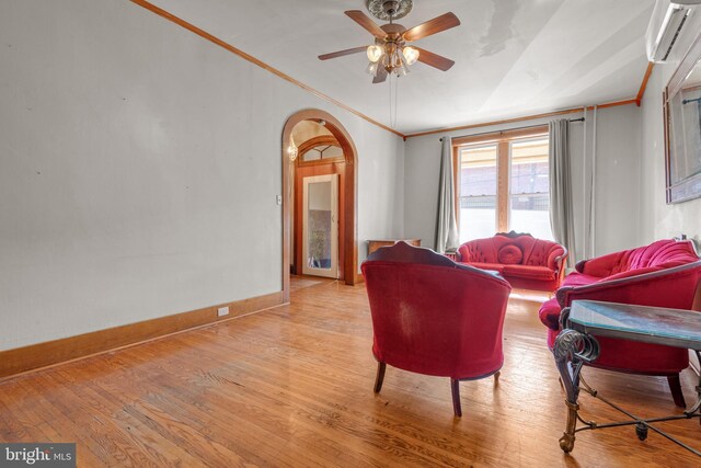 336 7th St N, Lebanon, PA 17042 - living room with a ceiling fan, crown molding, arched walkways, and light wood-type flooring