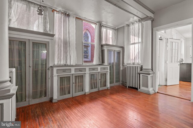 336 7th St N, Lebanon, PA 17042 - unfurnished room featuring decorative columns, radiator, and hardwood / wood-style floors