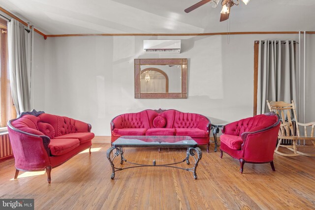 336 7th St N, Lebanon, PA 17042 - living room featuring ceiling fan, wood finished floors, a wall mounted air conditioner, and ornamental molding