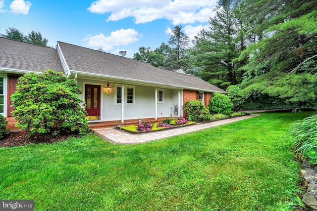 6 Deer Haven Ln, White Hall, MD 21161 - view of front of house with a front yard, covered porch, and a shingled roof