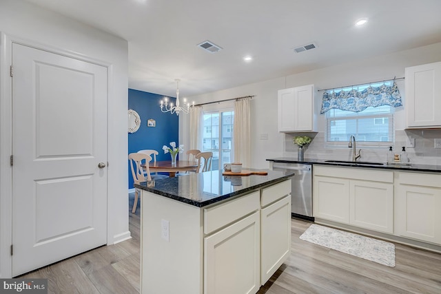 12086 Geyer Ave, Milford, DE 19963 - kitchen with visible vents, a sink, light wood-type flooring, an inviting chandelier, and stainless steel dishwasher